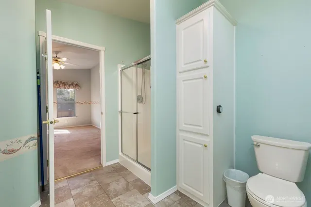 an empty room with closet and a bathroom