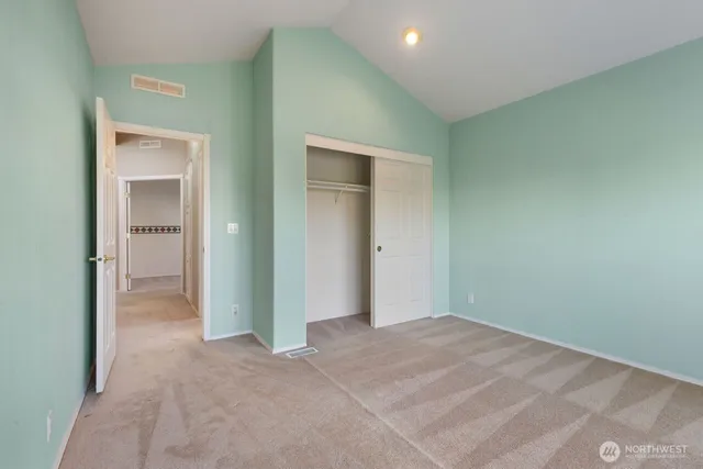an empty room with a large window and front door