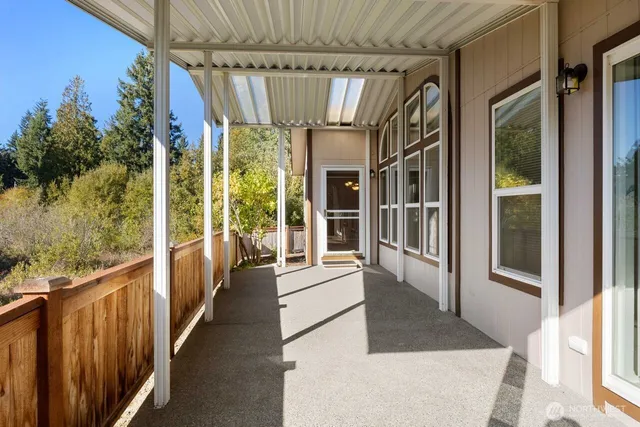 an aerial view of a house with swimming pool and large trees