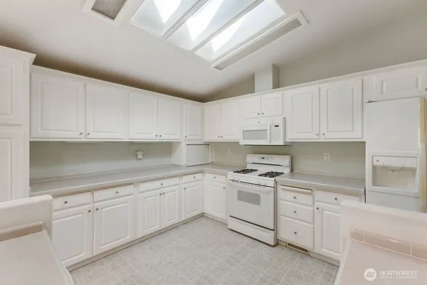 a kitchen with white cabinets