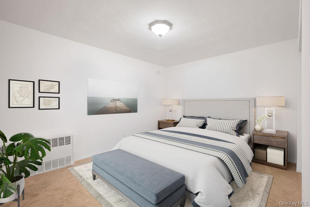 103 Wiltshire Road, Unit D6 Scarsdale, NY 10583 - Photo 13 of 20 a bedroom with a bed and paintings on the wall