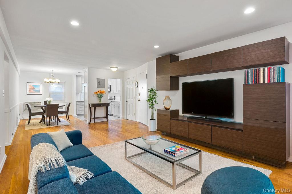 103 Wiltshire Road, Unit D6 Scarsdale, NY 10583 - Photo 4 of 20 a living room with furniture and a flat screen tv