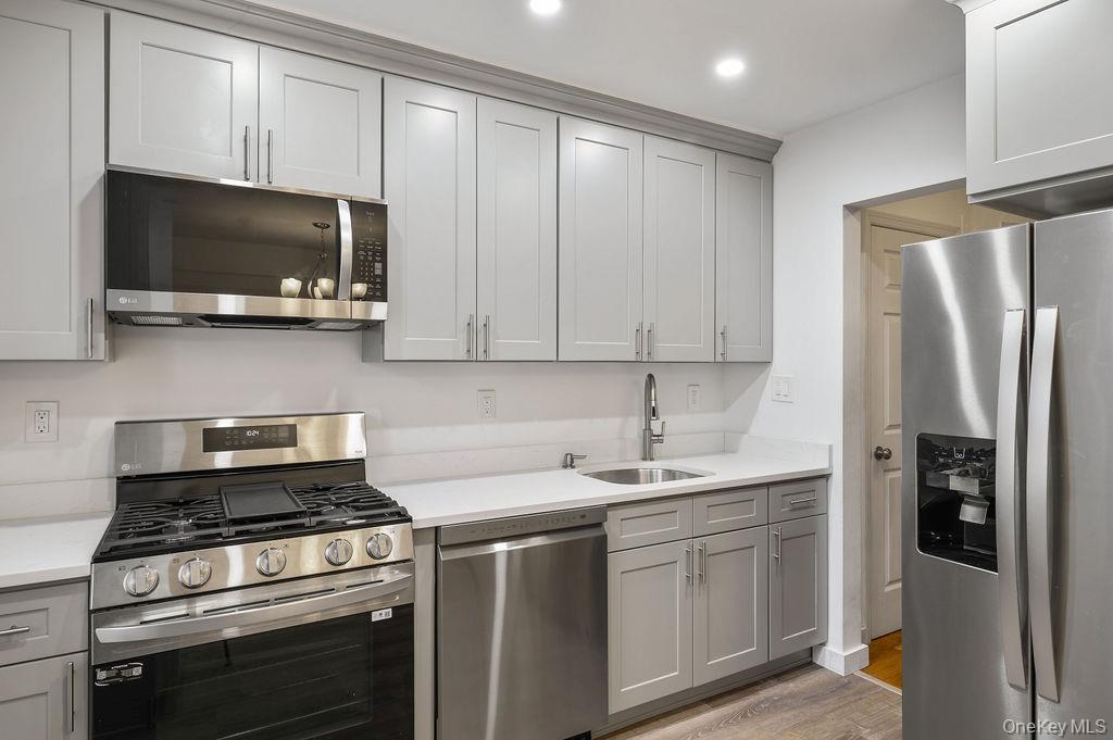 103 Wiltshire Road, Unit D6 Scarsdale, NY 10583 - Photo 9 of 20 a kitchen with stainless steel appliances a stove a microwave and a sink