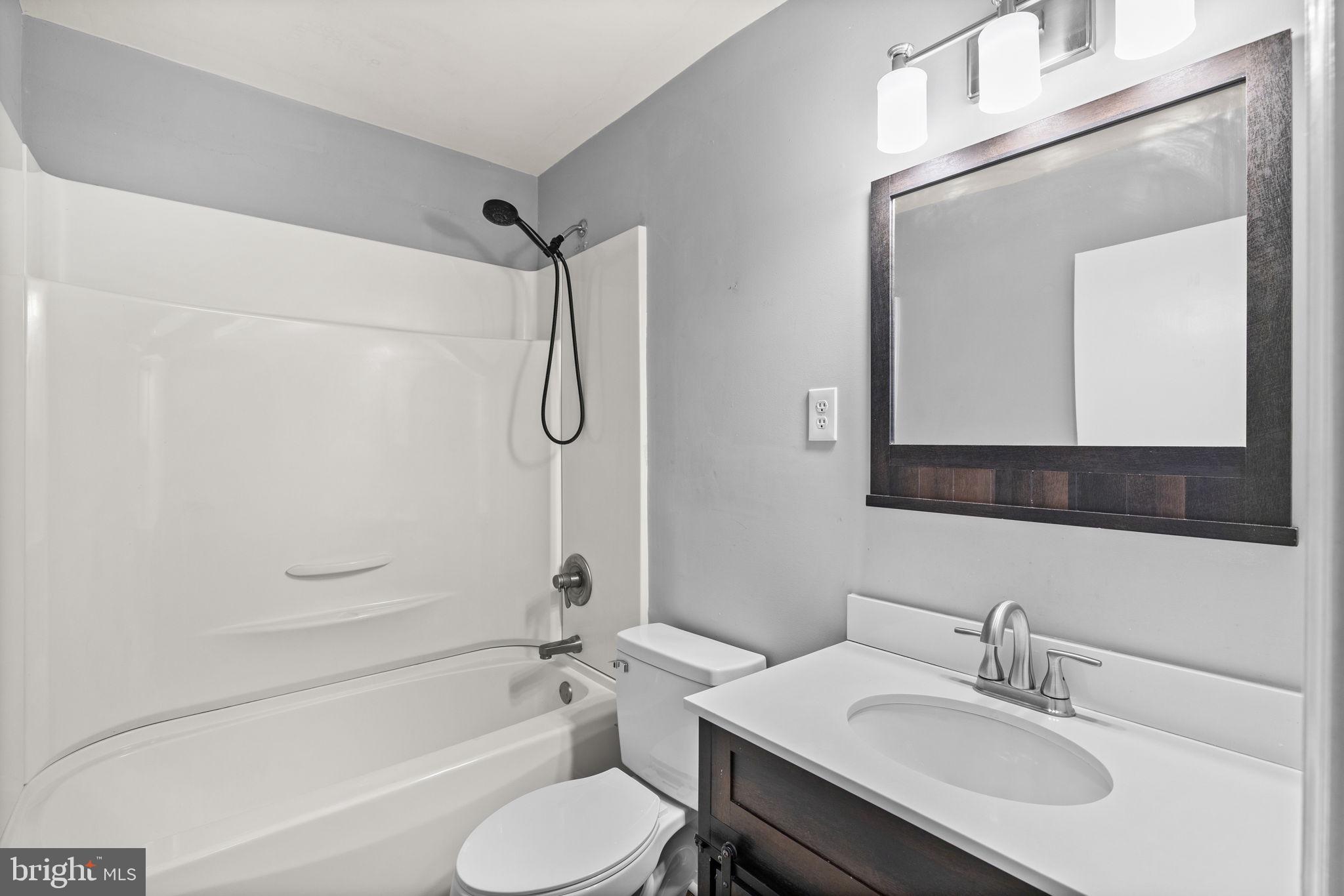 727 Chalklevel Road Louisa, VA 23093 - Photo 14 of 49 a bathroom with a sink toilet tub vanity and shower