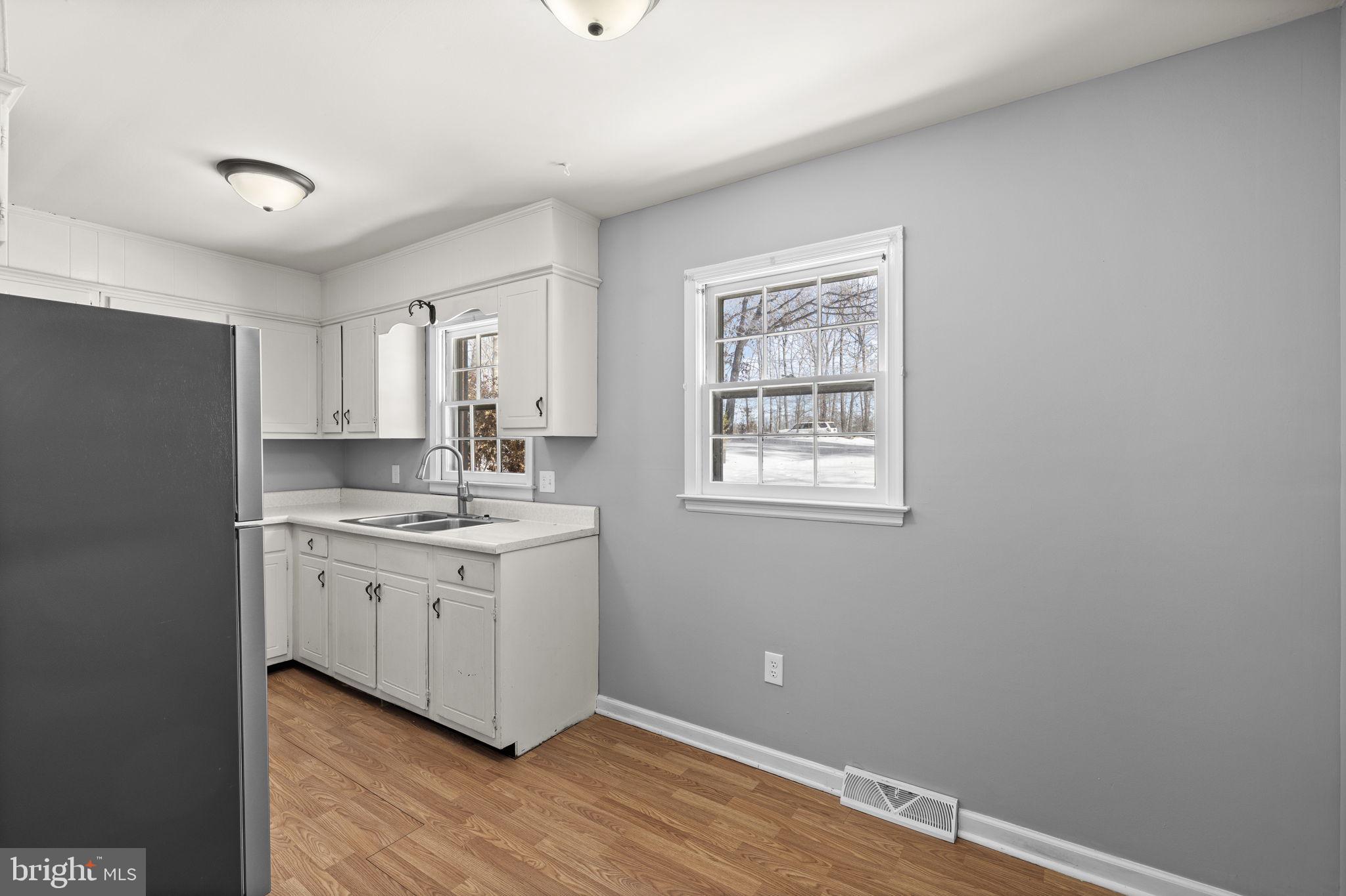 727 Chalklevel Road Louisa, VA 23093 - Photo 15 of 49 a kitchen with a sink cabinets and wooden floor