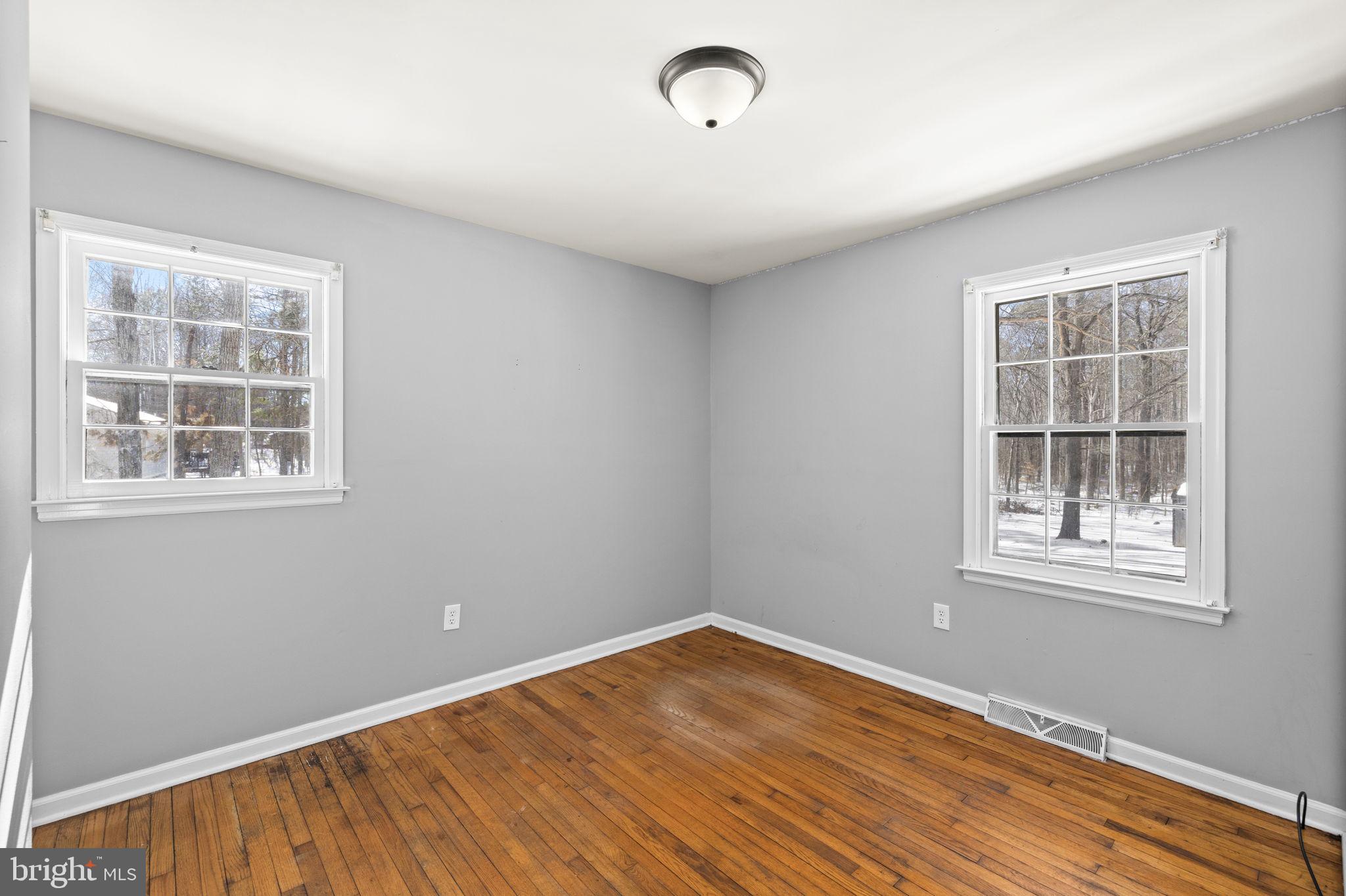 727 Chalklevel Road Louisa, VA 23093 - Photo 8 of 49 an empty room with wooden floor and windows