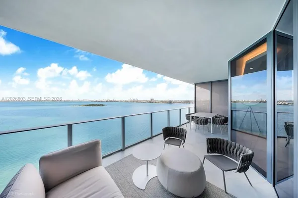 a living room with furniture and a floor to ceiling window