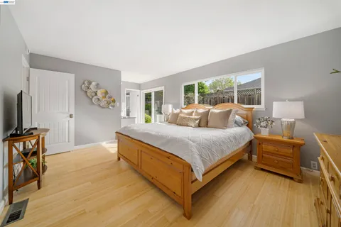 a bed sitting in a bedroom next to a window