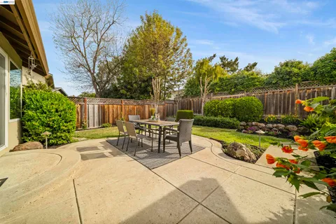 a view of a house with backyard porch and sitting area