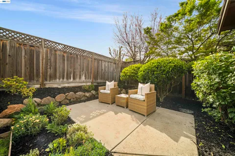 an aerial view of a house with yard and patio