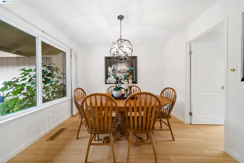 a view of a dining room with furniture wooden floor and chandelier