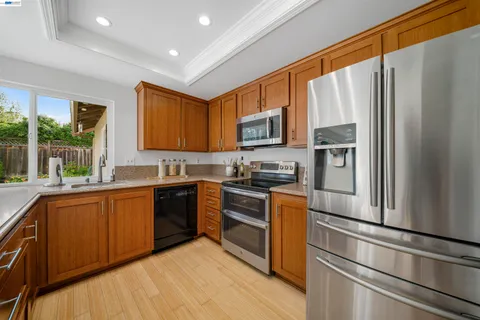 a kitchen with a sink and wooden cabinets