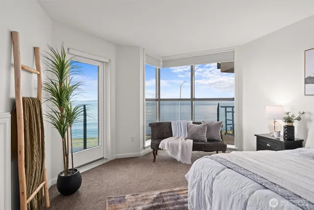 a bedroom with furniture and a large window