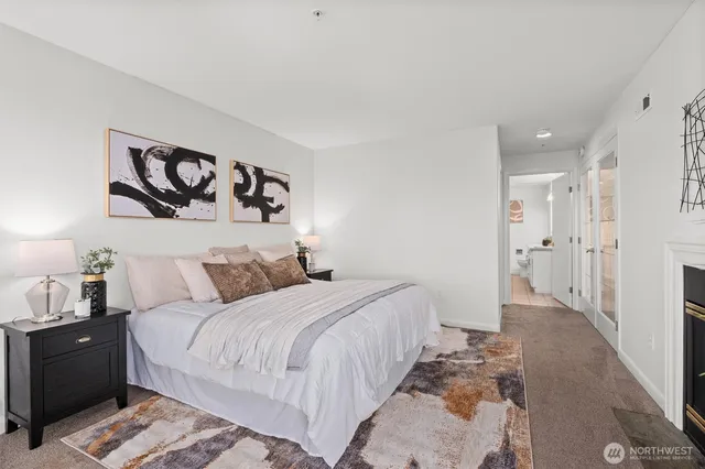 a bedroom with a bed and a painting on the wall