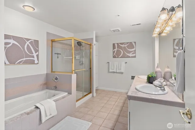 a bathroom with a sink a bathtub and a shower