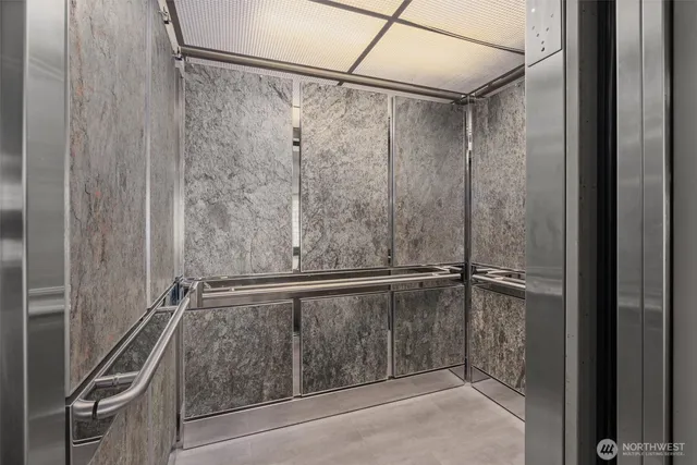a bathroom with a shower and a glass door