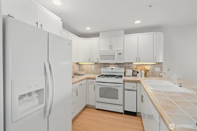 a kitchen with cabinets appliances and a sink