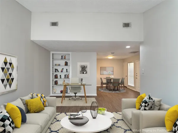 a living room with furniture and kitchen view