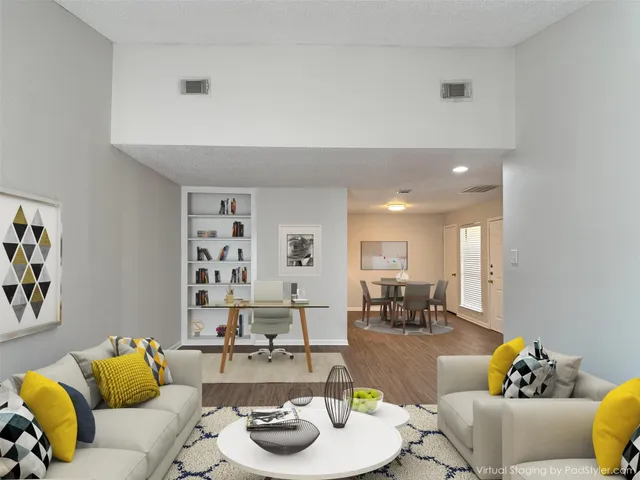 a living room with furniture and kitchen view