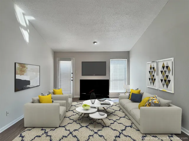 an empty room with a fireplace and wooden floor