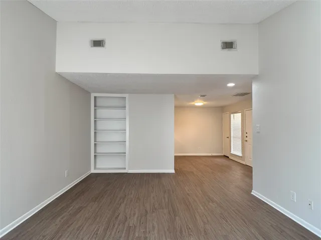 a living room with a fireplace and a rug