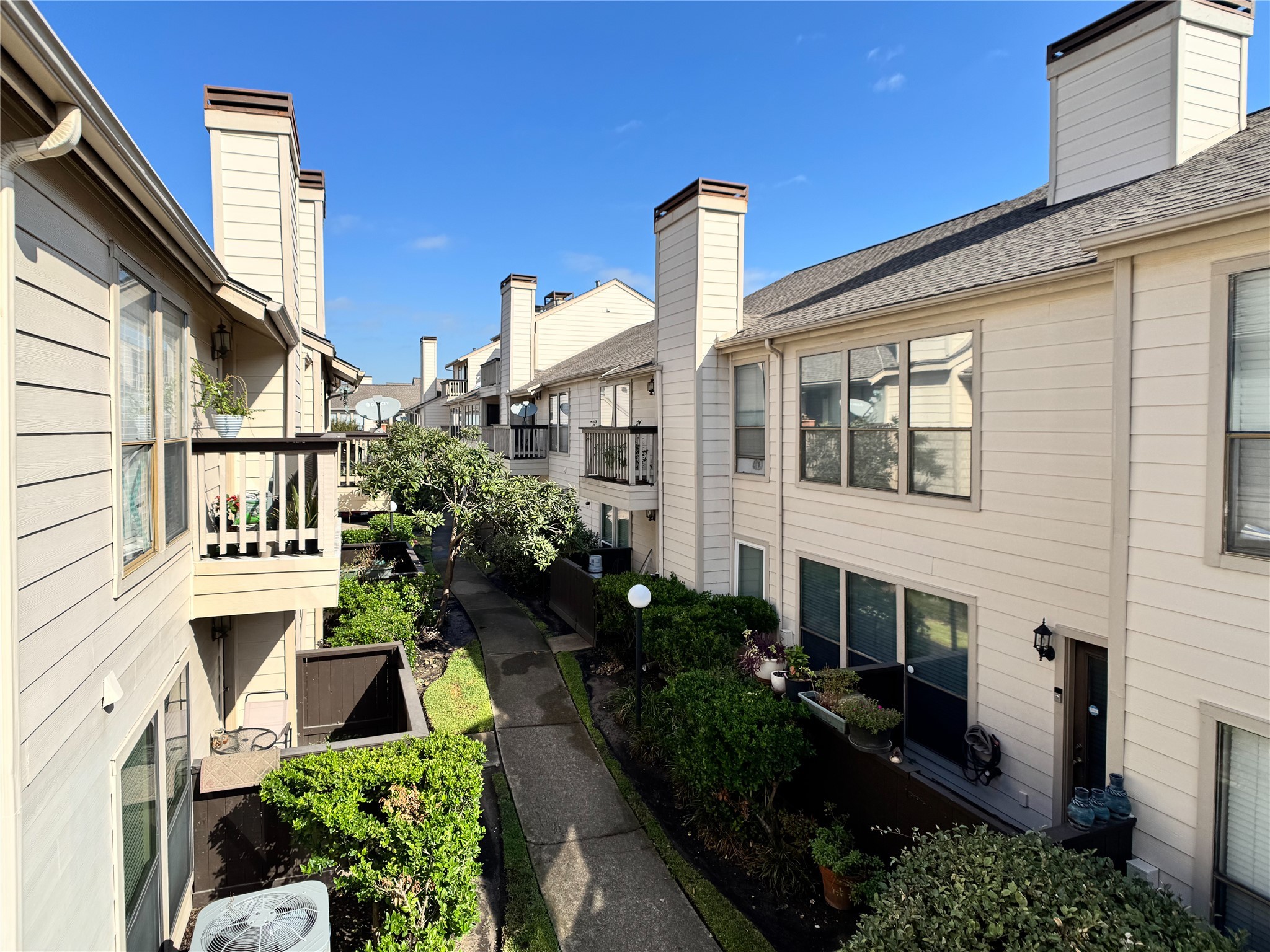 2277 South Kirkwood Road, Unit 404 Houston, TX 77077 - Photo 20 of 39 a front view of a house with plants