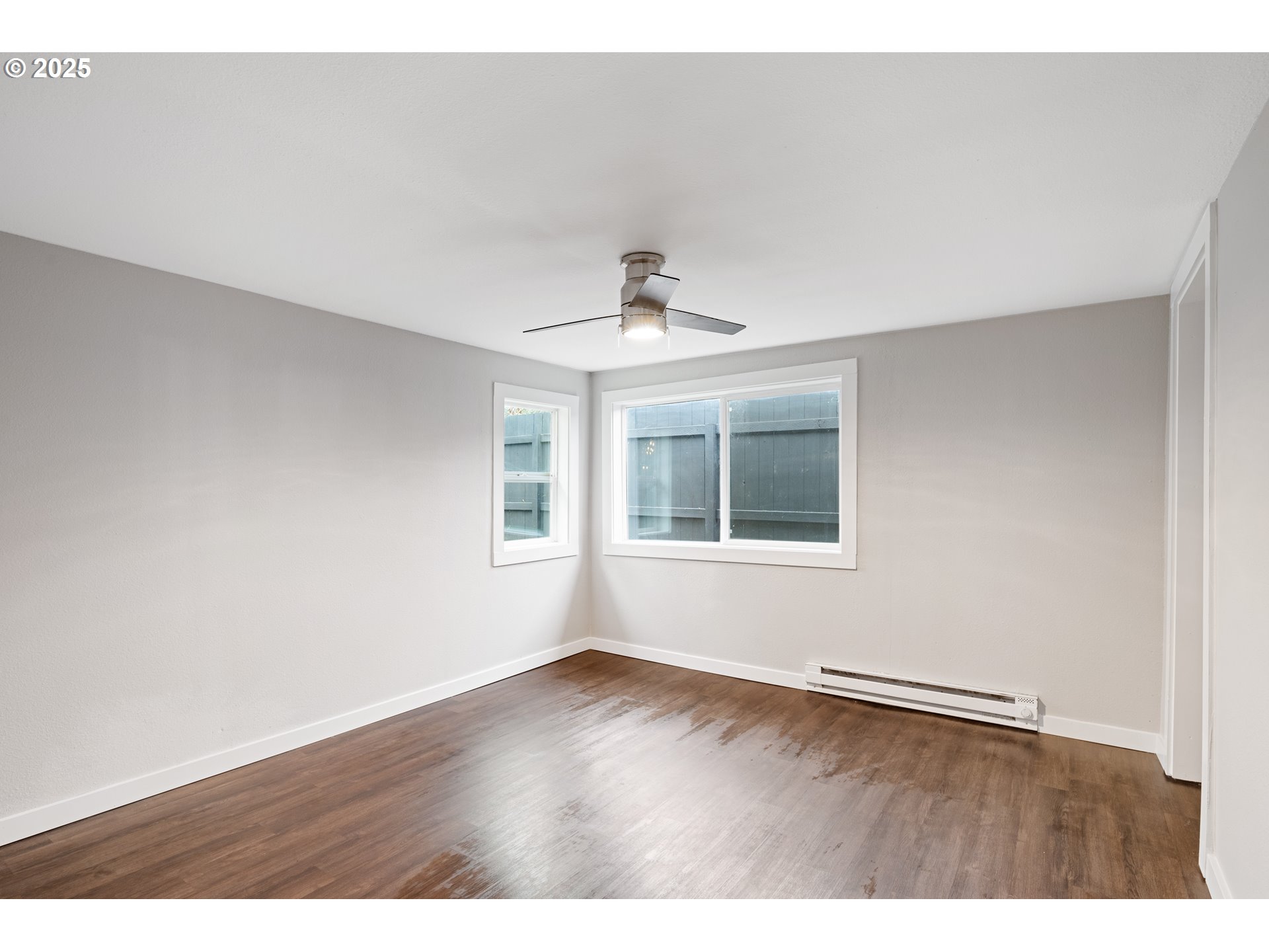 3317 Olive Way Longview, WA 98632 - Photo 12 of 29 a view of an empty room with wooden floor and a window