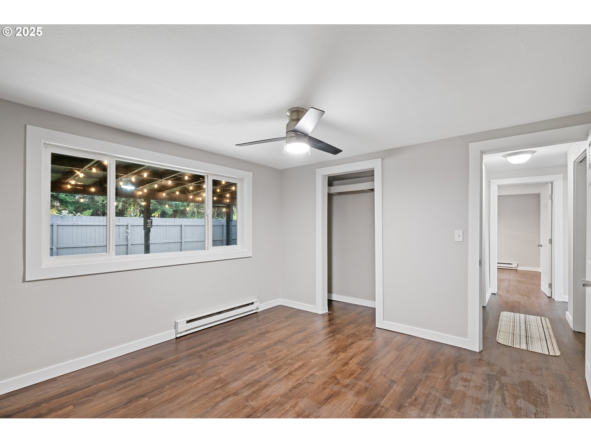 3317 Olive Way Longview, WA 98632 - Photo 16 of 29 a view of an empty room with wooden floor and a window