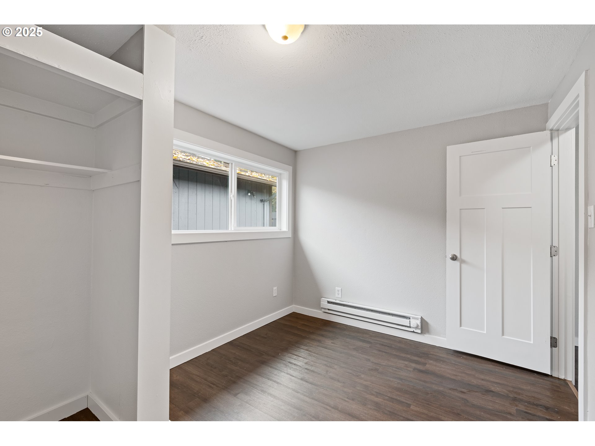 3317 Olive Way Longview, WA 98632 - Photo 19 of 29 a view of an empty room with wooden floor and closet