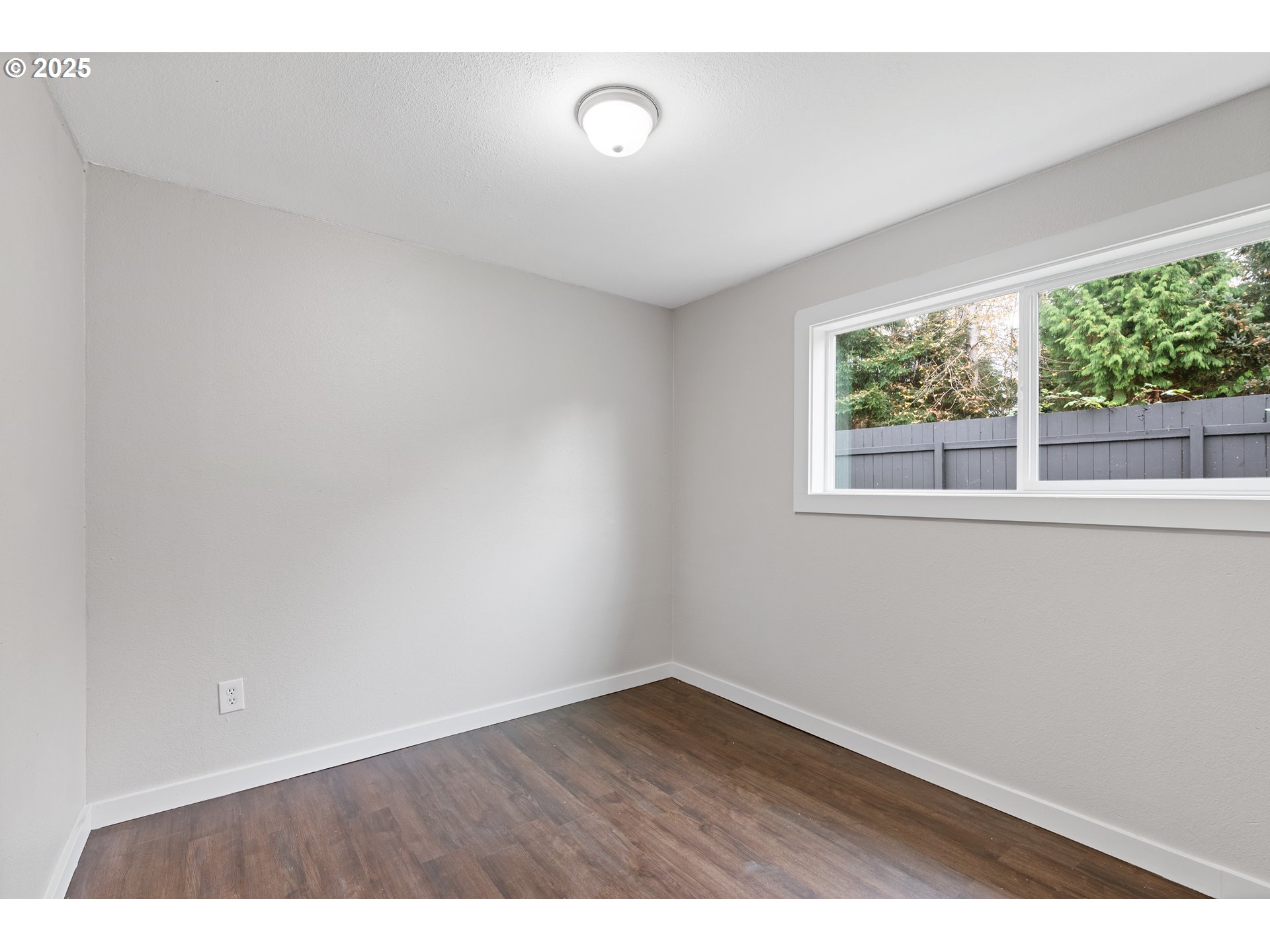 3317 Olive Way Longview, WA 98632 - Photo 20 of 29 an empty room with wooden floor and windows