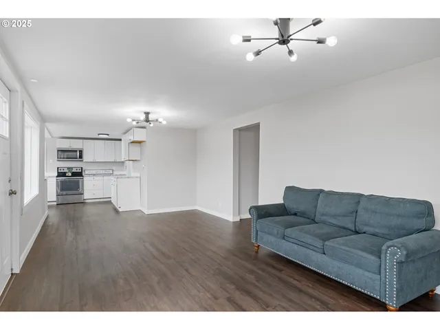 a living room with furniture and kitchen view