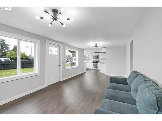 a living room with furniture and a chandelier
