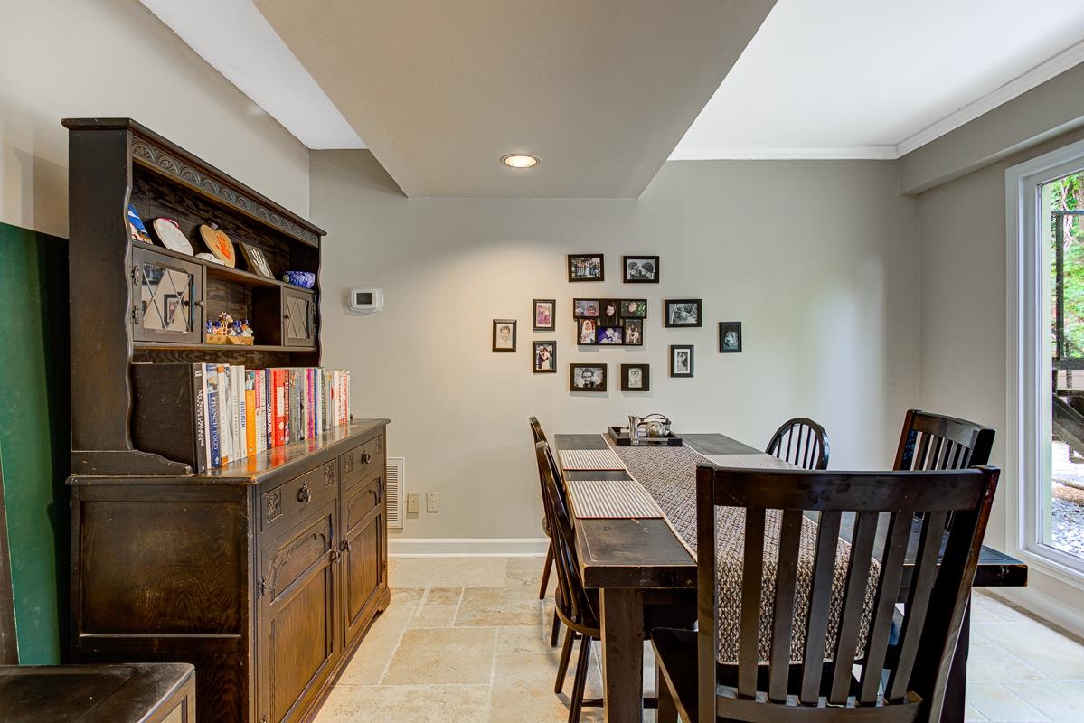 5699 Normandy Road Memphis, TN 38120 - Photo 10 of 34 Dining area featuring a full-light glass door, recessed lighting, and tile flooring