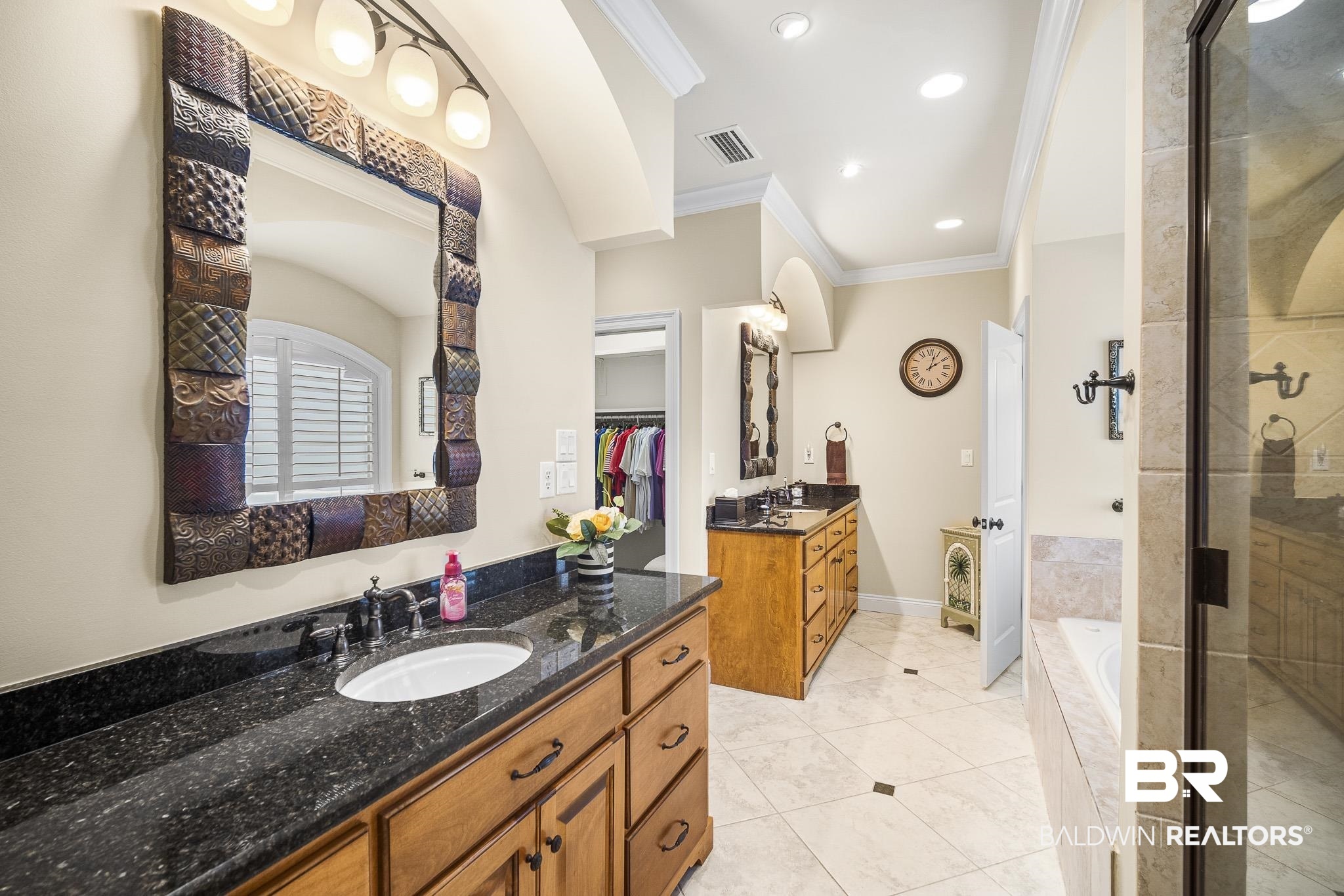 7090 Carson Lane Daphne, AL 36527 - Photo 17 of 37 Bathroom featuring plus walk in shower, ornamental molding, double vanity, and tile patterned flooring