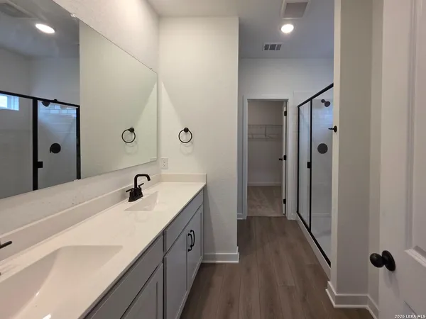 a view of a hallway with wooden floor and closet