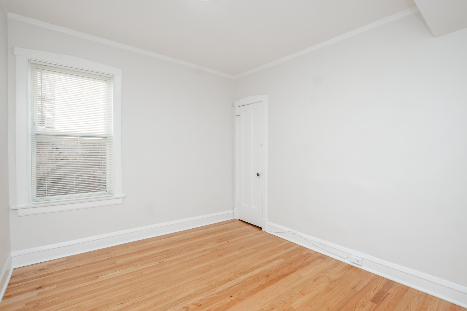 2136 North Avers Avenue, Unit 2 Chicago, IL 60647 - Photo 11 of 21 an empty room with wooden floor and windows
