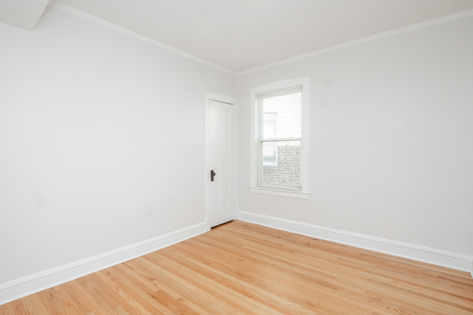 2136 North Avers Avenue, Unit 2 Chicago, IL 60647 - Photo 12 of 21 an empty room with wooden floor and windows