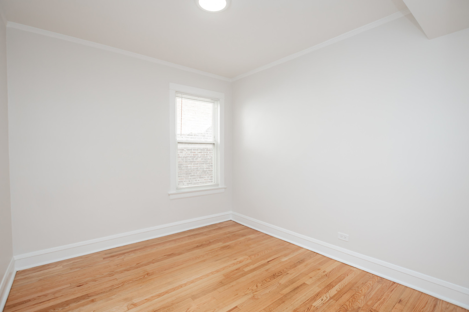 2136 North Avers Avenue, Unit 2 Chicago, IL 60647 - Photo 15 of 21 an empty room with wooden floor and windows