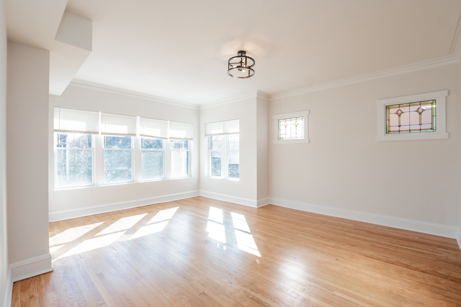 2136 North Avers Avenue, Unit 2 Chicago, IL 60647 - Photo 3 of 21 a view of an empty room with wooden floor and a window