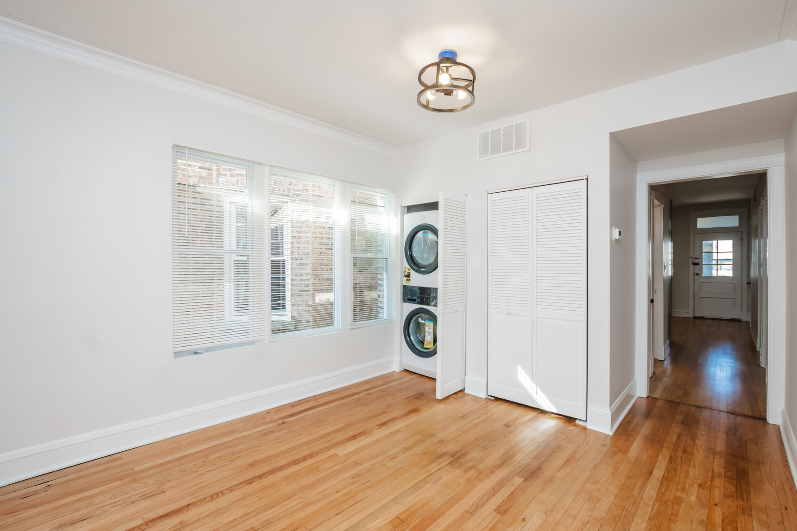 2136 North Avers Avenue, Unit 2 Chicago, IL 60647 - Photo 6 of 21 an empty room with wooden floor and windows