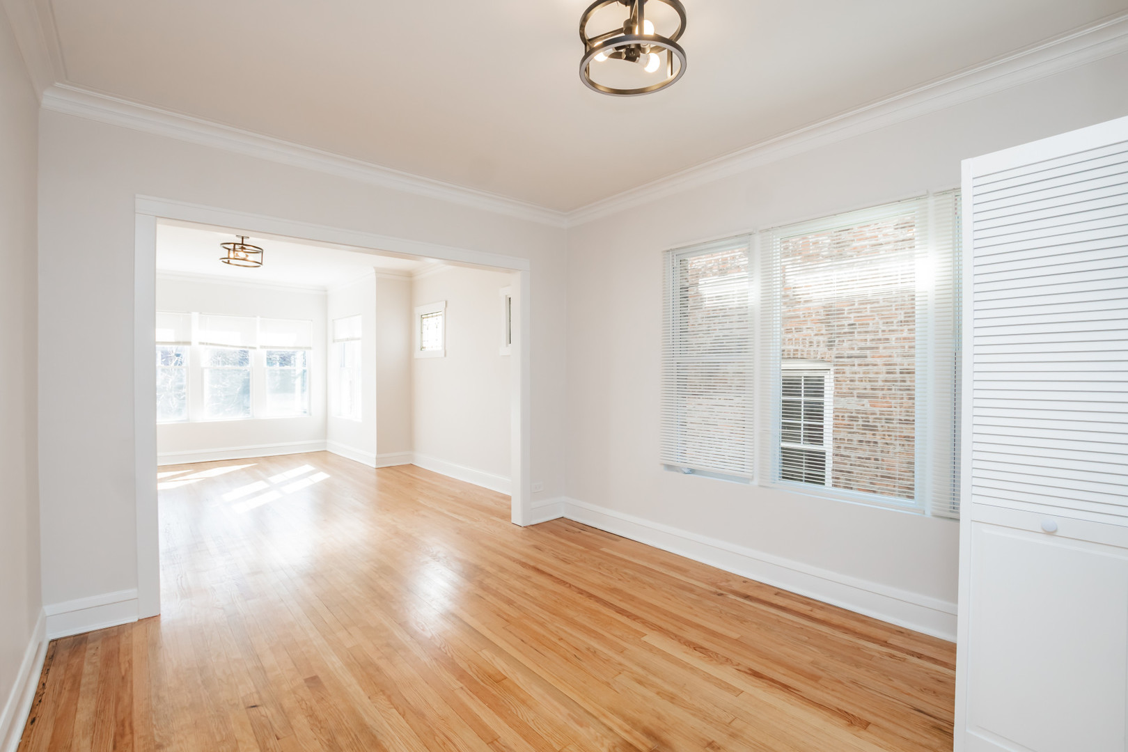 2136 North Avers Avenue, Unit 2 Chicago, IL 60647 - Photo 7 of 21 a view of an empty room with wooden floor and a window