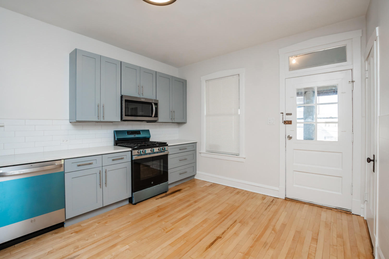 2136 North Avers Avenue, Unit 2 Chicago, IL 60647 - Photo 8 of 21 a kitchen with granite countertop stainless steel appliances and wooden cabinets