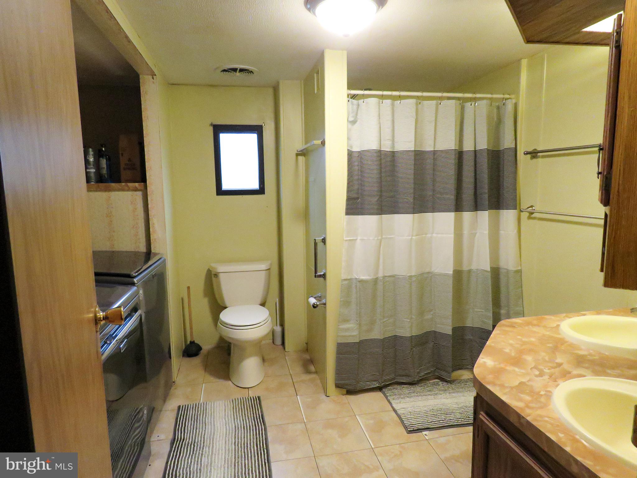 2379 River Road Bainbridge, PA 17502 - Photo 10 of 15 a spacious bathroom with a granite countertop toilet a sink and a shower