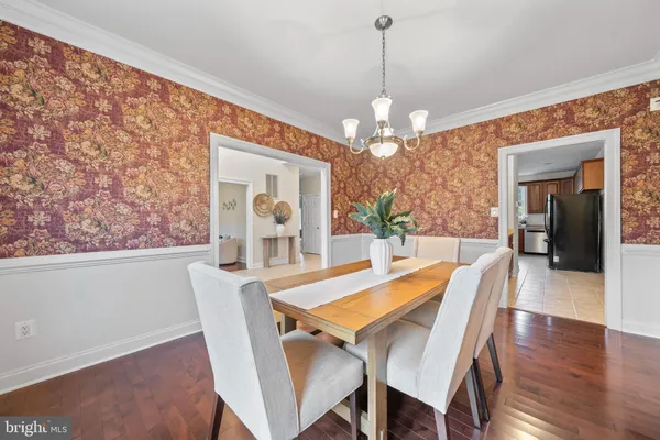 a kitchen with kitchen island a counter top space a sink stainless steel appliances and cabinets