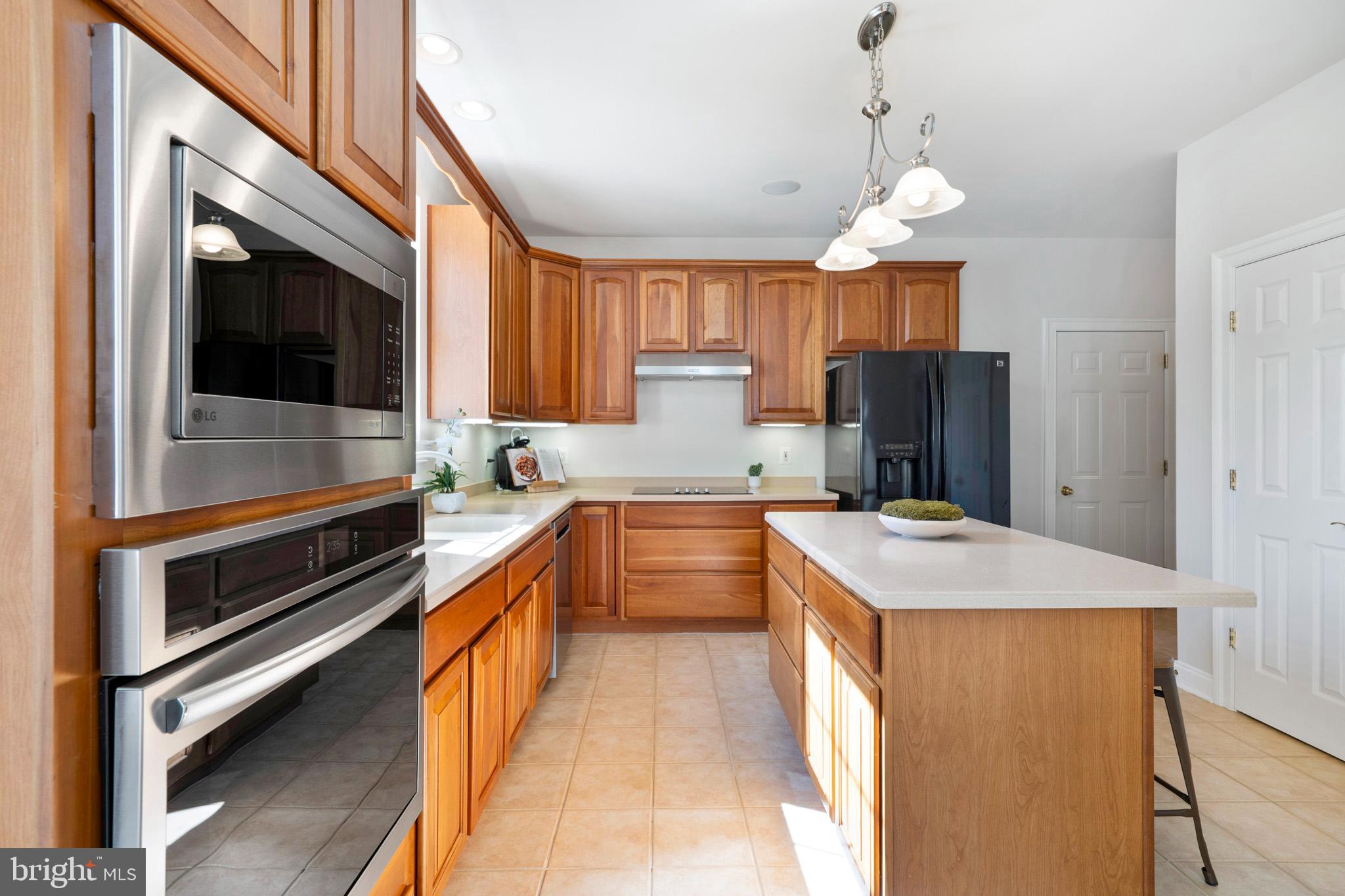 3300 Lancer Court Dunkirk, MD 20754 - Photo 19 of 89 a kitchen with kitchen island a counter top space a sink stainless steel appliances and cabinets