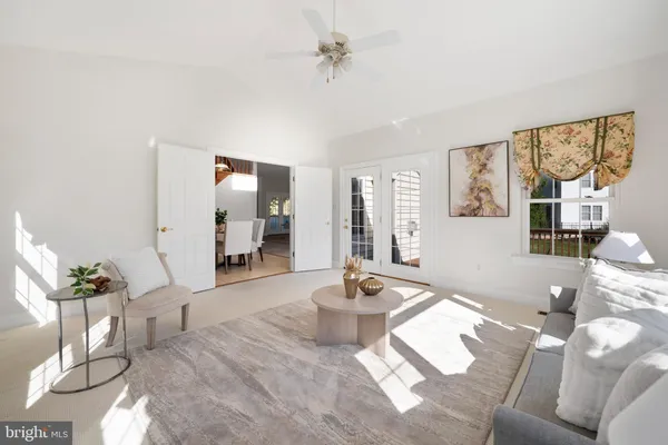 a view of a livingroom with a ceiling fan and window