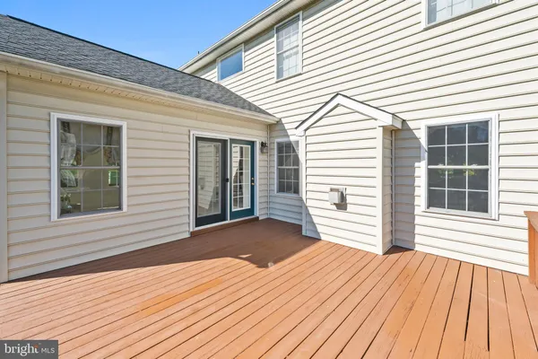 a view of a hallway with wooden floor and a window