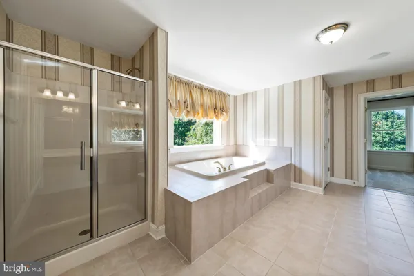 a view of a big house with a big yard and large trees