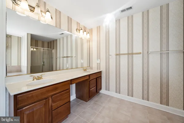 a front view of a house with a garden and trees