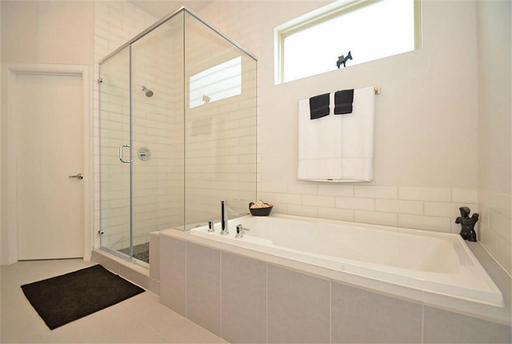 2713 Clay Street Houston, TX 77003 - Photo 18 of 24 The Master Bathroom features a Whirlpool tub & stand up shower. Large walk in closet for the Master is located behind the door.